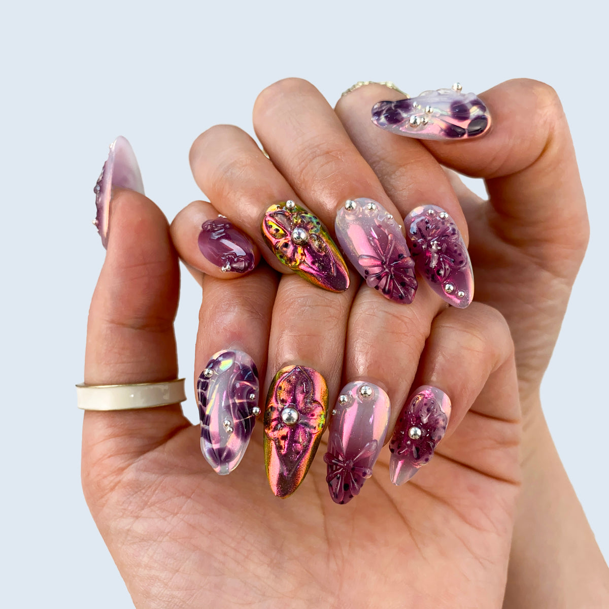 Violet Gleam nail art close-up showing deep galaxy cat eye shimmer and glossy gel finish