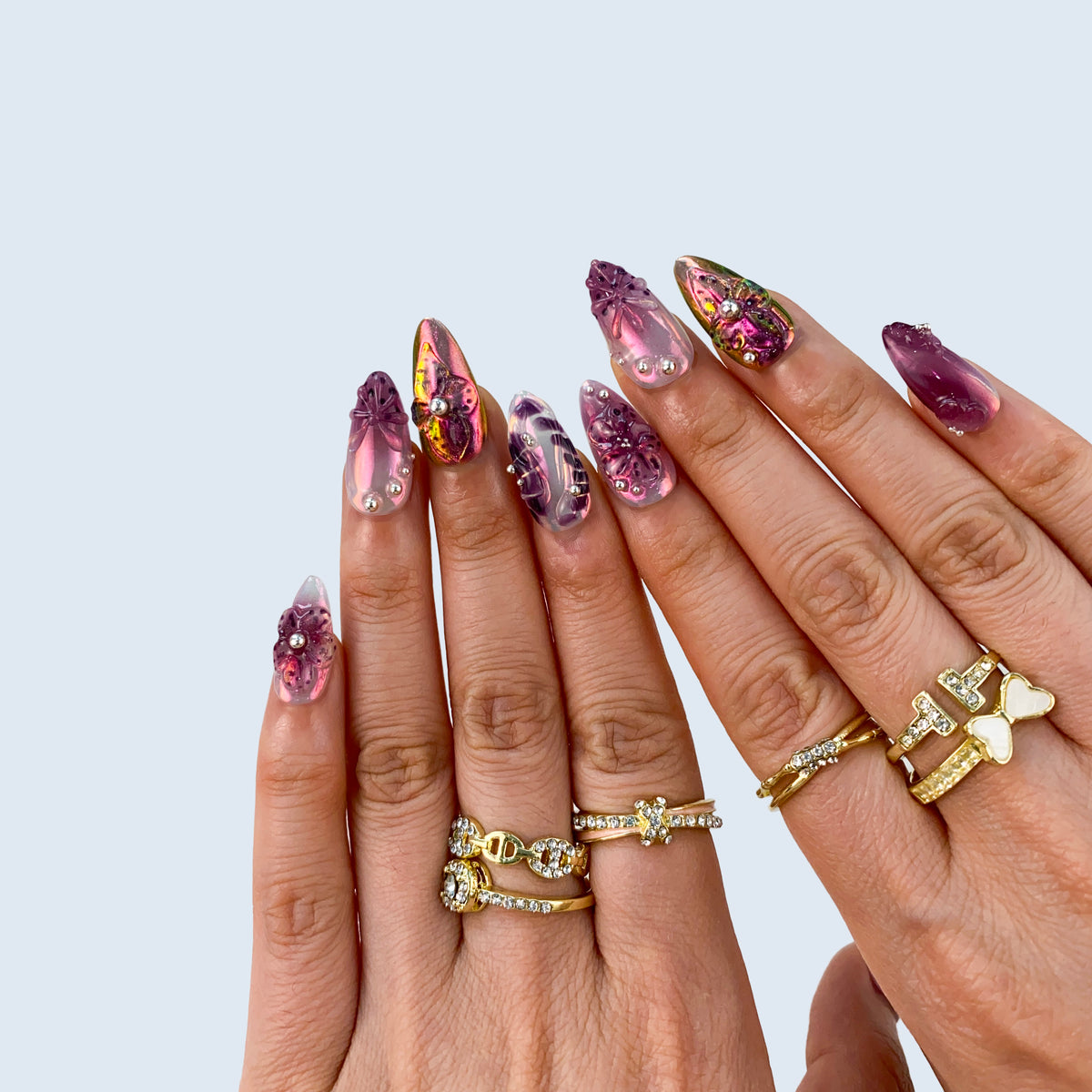 Handcrafted purple almond fake nails in natural light for evening parties and concerts