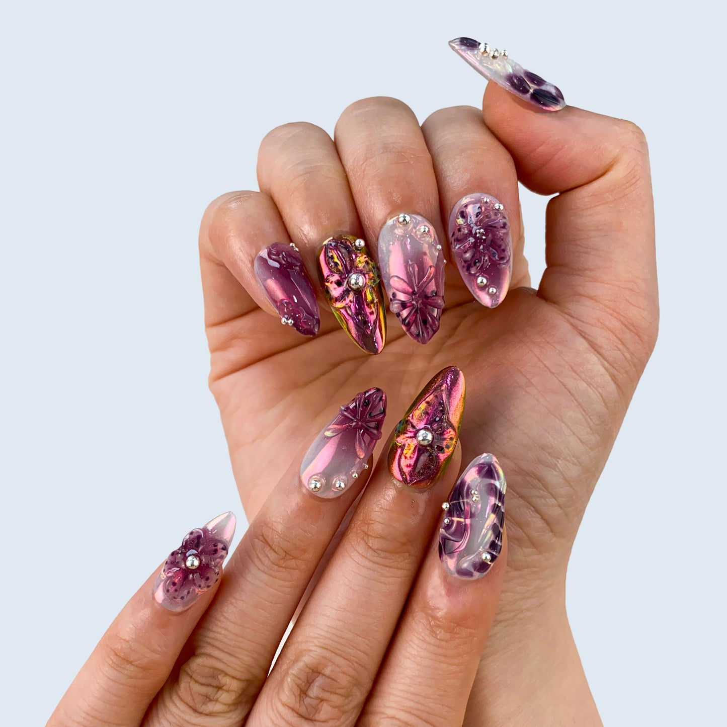 Luxury purple glow velvet cat eye gel manicure on hands close up
