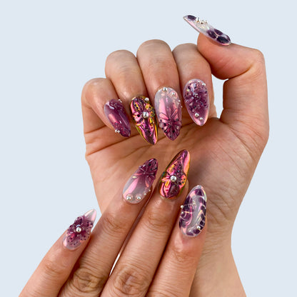 Luxury purple glow velvet cat eye gel manicure on hands close up