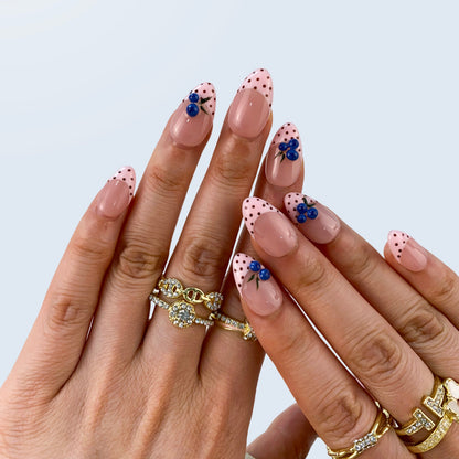 Berry Bliss nail art close-up showing handcrafted art detailing on almond nails