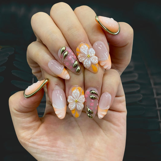 Floral Garden gold press-on nails on hand | Floral Garden nail inspo