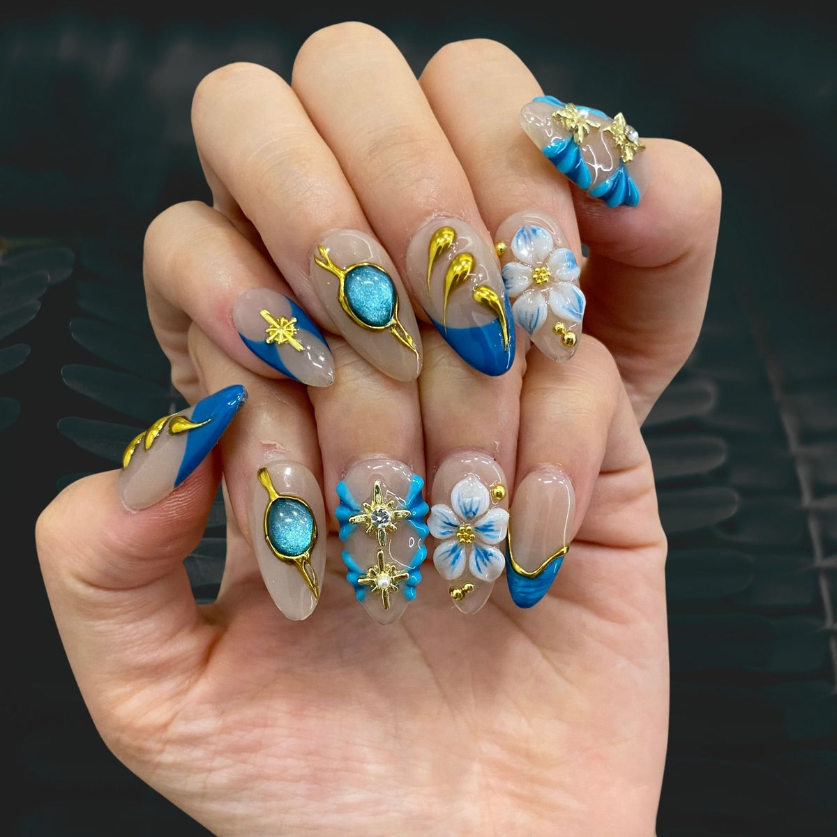 Celestial Shore almond press-on nails shown on hand in indoor lighting display