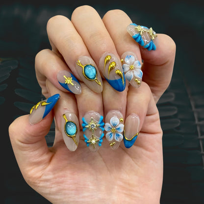 Celestial Shore almond press-on nails shown on hand in indoor lighting display