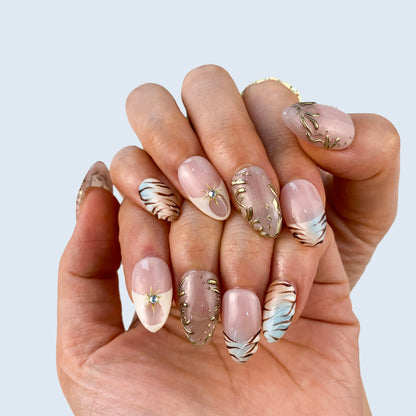 Aurora Veil nail art close-up showing celestial charms and aurora shimmer on almond nails