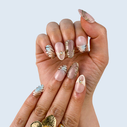 Luxury aurora lilac gel manicure with celestial charms and aurora shimmer on hands close up