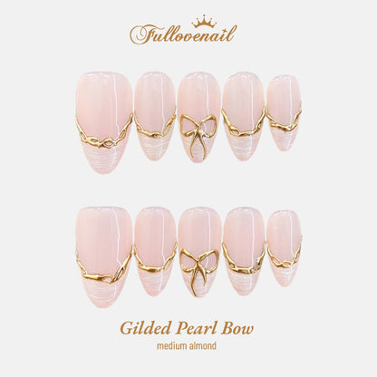 Gilded Pearl Bow almond press-on nails with 3D gold wire bows and French tips