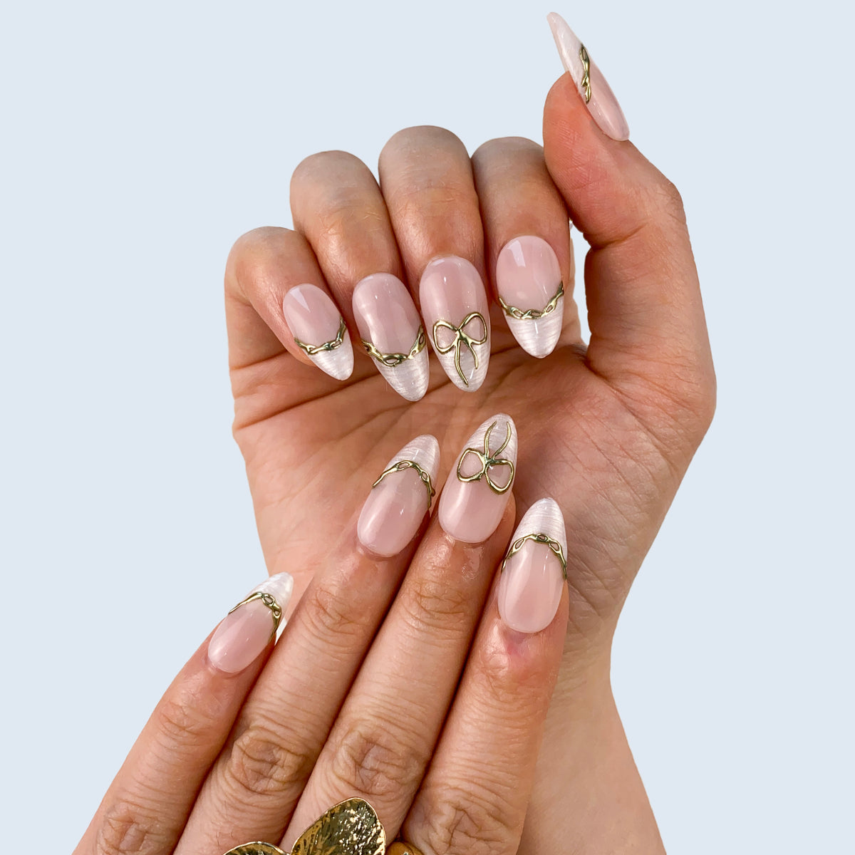 Full set wear display of Gilded Pearl Bow elegant white French press-on nails