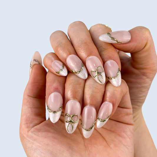 Coquette white press-on nails on hand | Coquette nail inspo