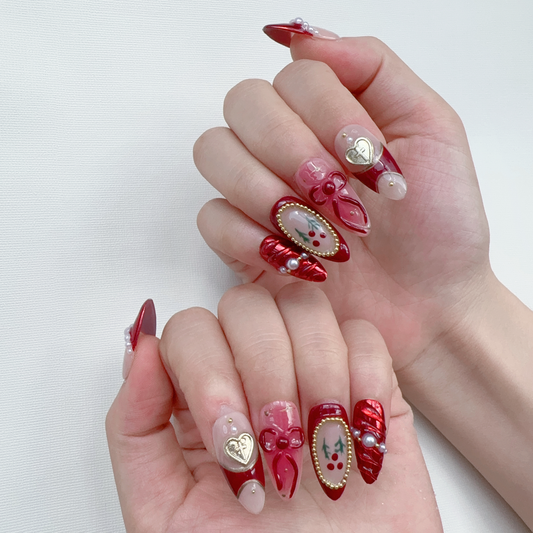 Coquette red press-on nails on hand | Coquette nail inspo