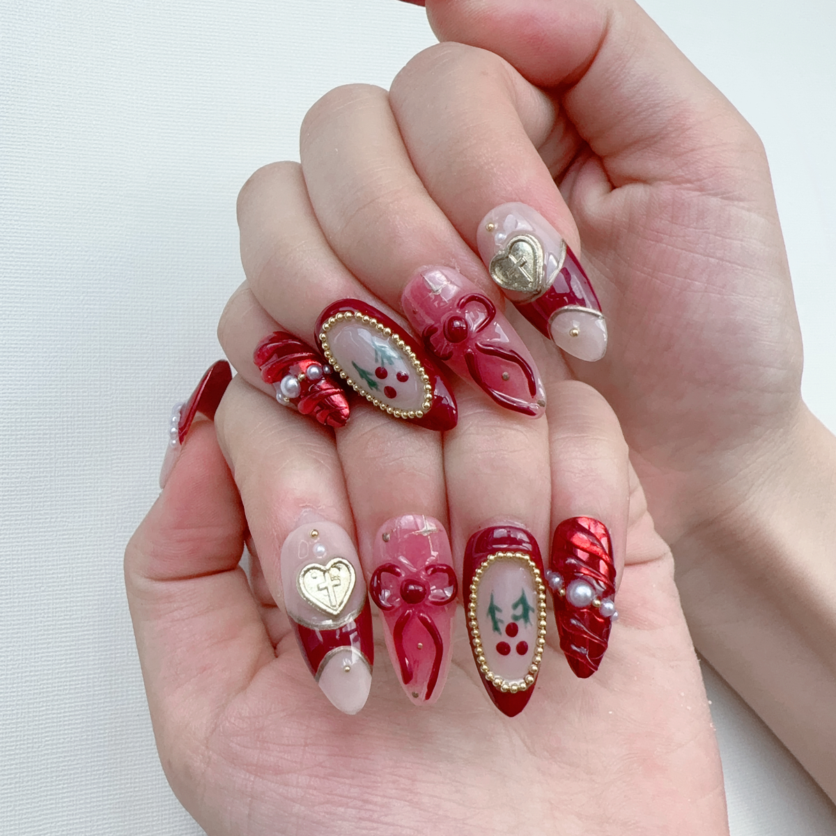 Close-up on-hand photo of Deck the Nails featuring metallic red wrap accents