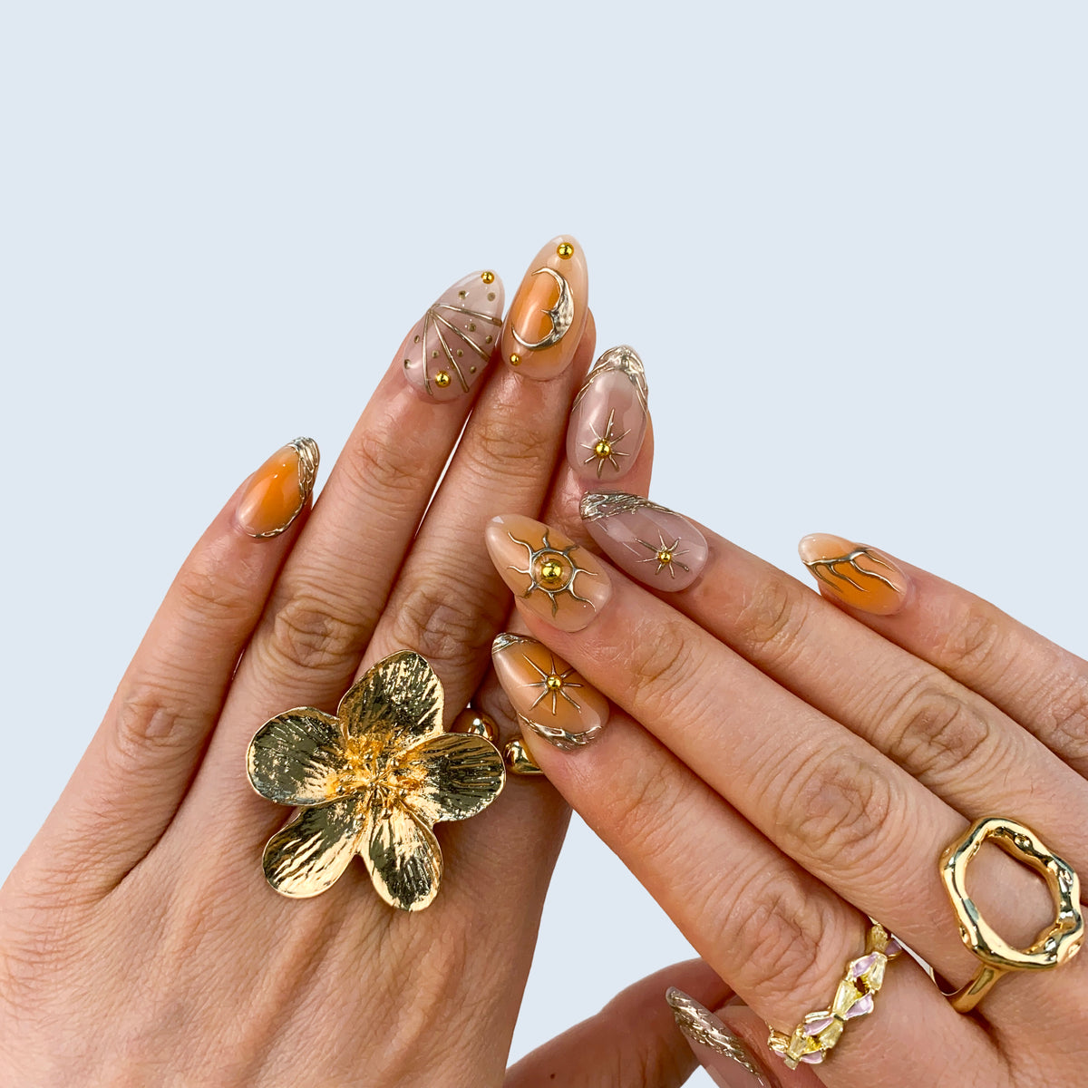Stellar Glow nail art close-up showing handcrafted art detailing on almond nails