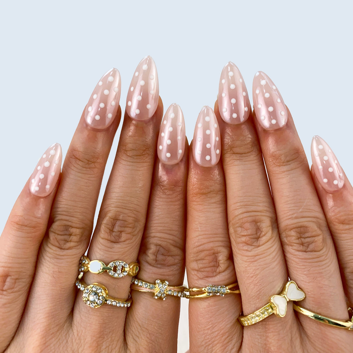Full set wear display of Polka Muse sheer nude and white dot almond nails