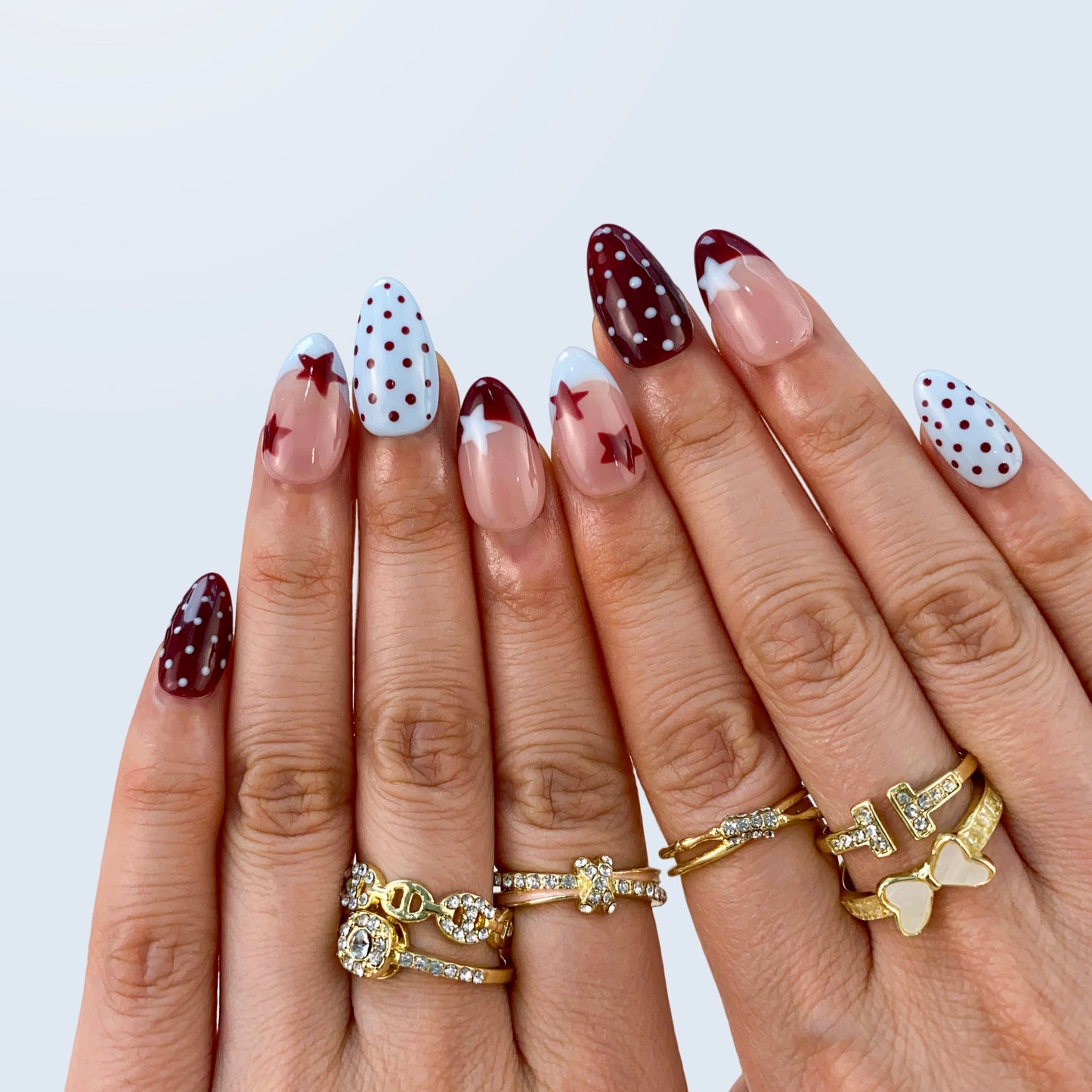 Handcrafted black and white polka dot gel fake nails in natural light for daily office styling