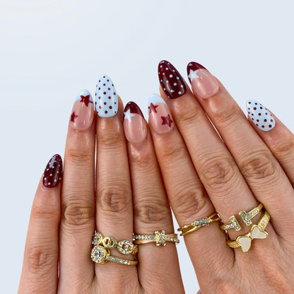 Handcrafted black and white polka dot gel fake nails in natural light for daily office styling