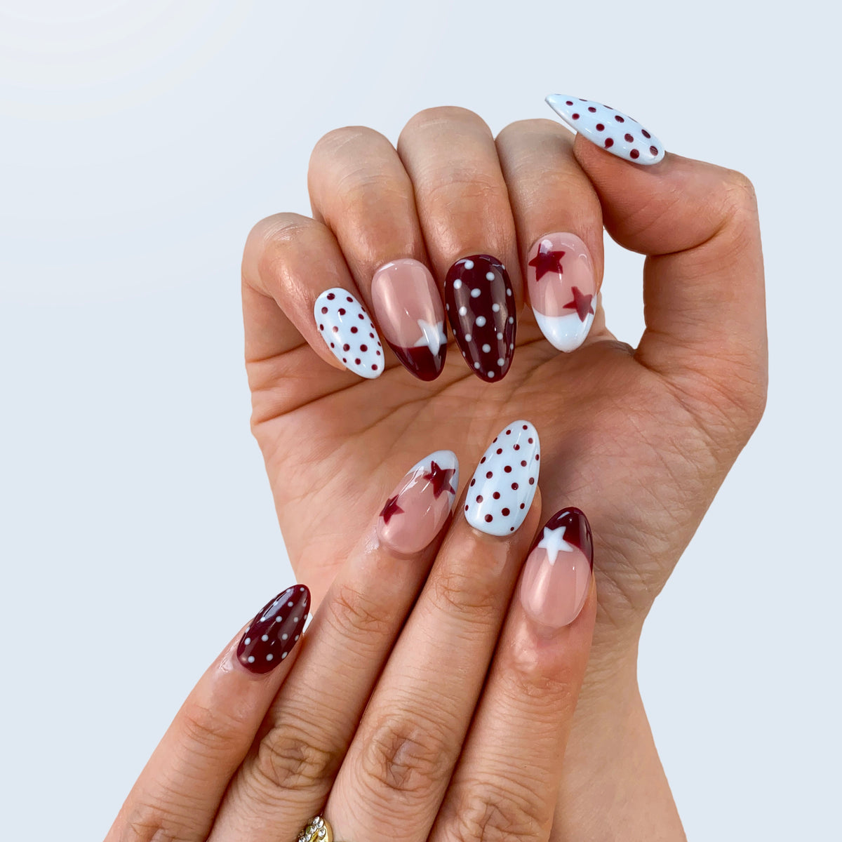Salon quality Vintage Polka Elegance reusable gel press-on nails with custom sizing on hands