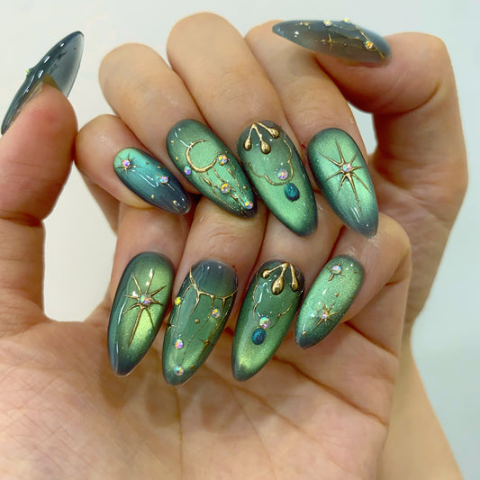 Deep emerald green velvet cat eye press-on nails on hand | Celestial mystery gothic nail inspo