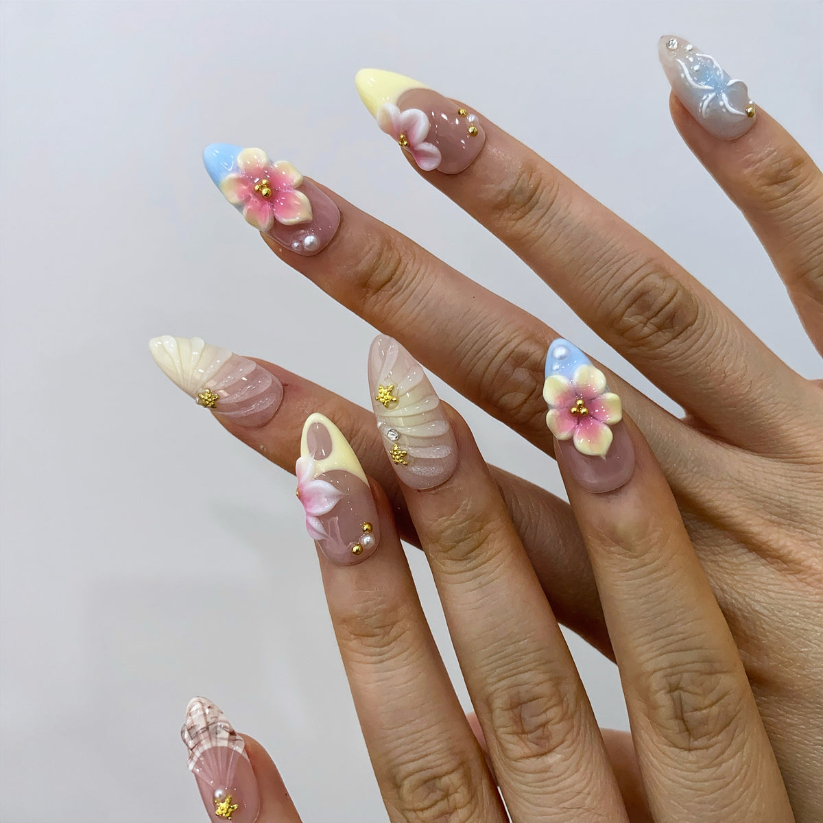 Angled view of Mermaid's Garden almond nails displaying 3D fluted seashell ridges