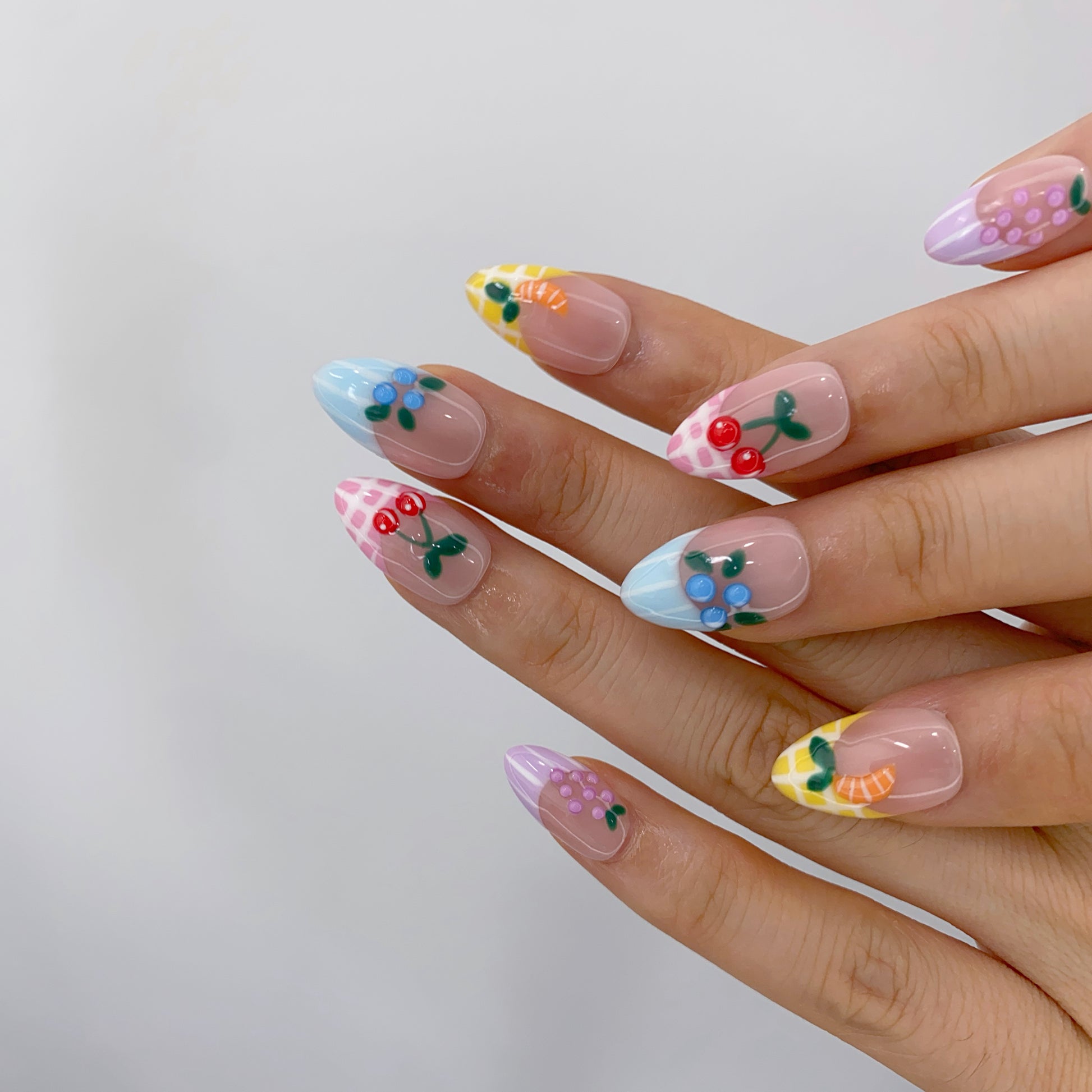 Salon quality Sorbet Orchard reusable gel press-on nails with custom sizing on natural hands