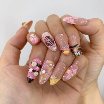 Both hands wearing Harajuku Sugar press-on nails displaying 3D dessert charms