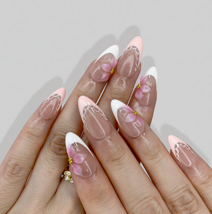 Angled view of Ballet Bloom press-on nails displaying scalloped French tips