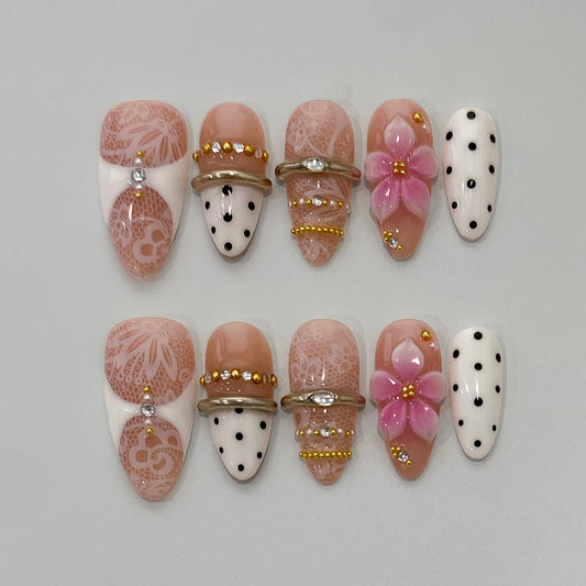 Coquette soft pink press-on nails on table | Coquette nail inspo