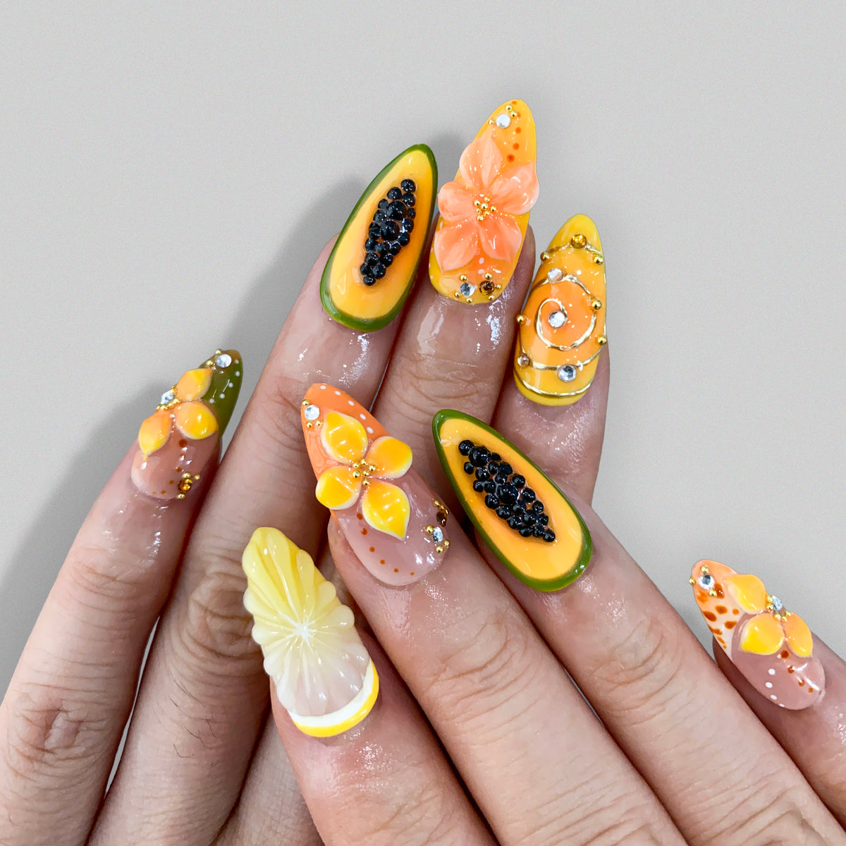 Real photo of Papaya Splash fruit press-on nails worn under bright natural light