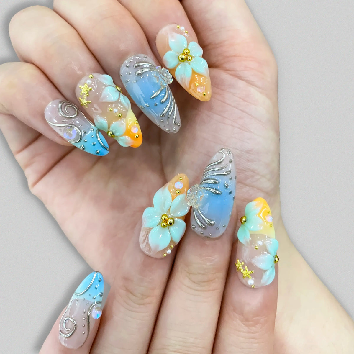 Fairycore aesthetic pastel almond nails worn on hands under natural light