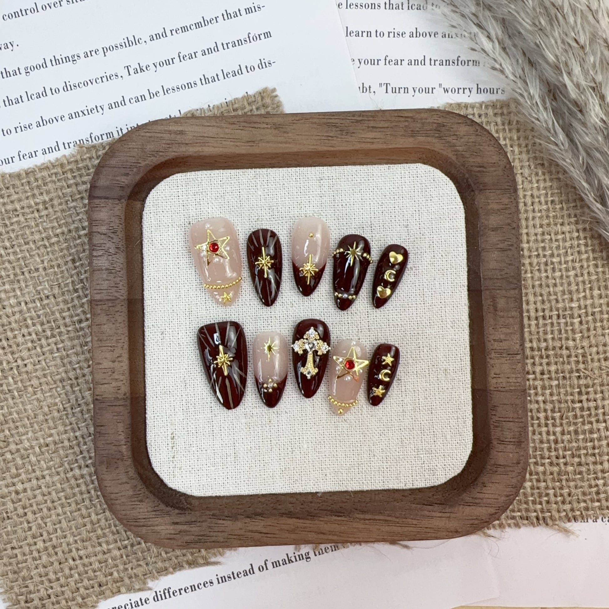 Full 10-piece set display of Gothic Romance oxblood and gold star press-on nails
