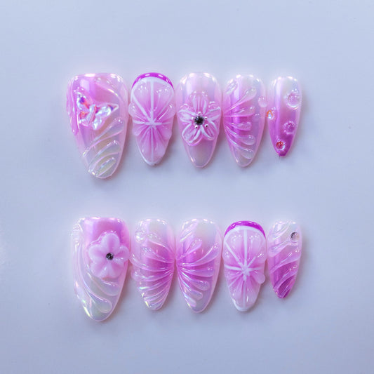 Purple Blush almond press-on nails with 3D floral petals and seashell ridges