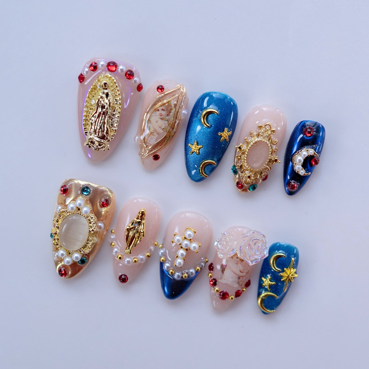 Celestial Grace nail art flat lay close-up showing celestial charms and aurora shimmer on almond nails
